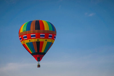 Low angle view of hot air balloon against blue sky