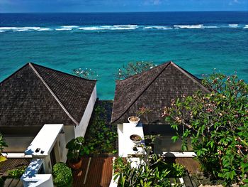 High angle view of buildings by sea against sky