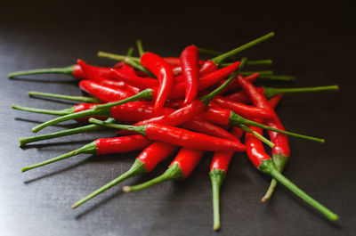 Close-up of red chili peppers on table