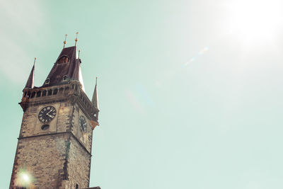 Low angle view of clock tower amidst buildings against sky