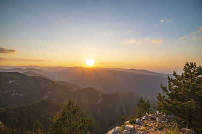 Scenic view of mountains against sky during sunset