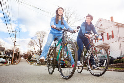 Couple riding bicycle on road