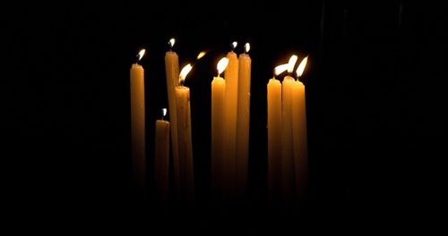 Lit candles in the dark