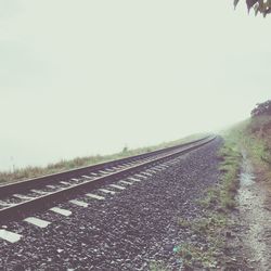 Surface level of railroad tracks against clear sky