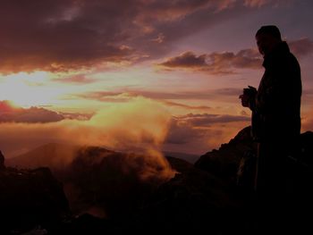 Man standing against sky during sunset