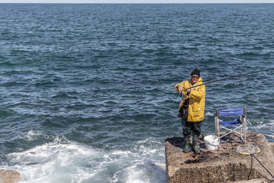 Rear view of man standing in sea