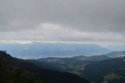 Scenic view of mountains against cloudy sky