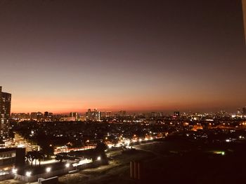 High angle view of illuminated buildings against sky at night