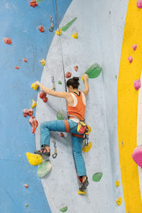 Woman climbing on wall