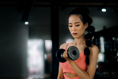 Midsection of woman standing against wall