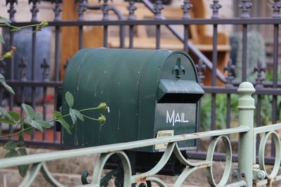 Close-up of mailbox by fence