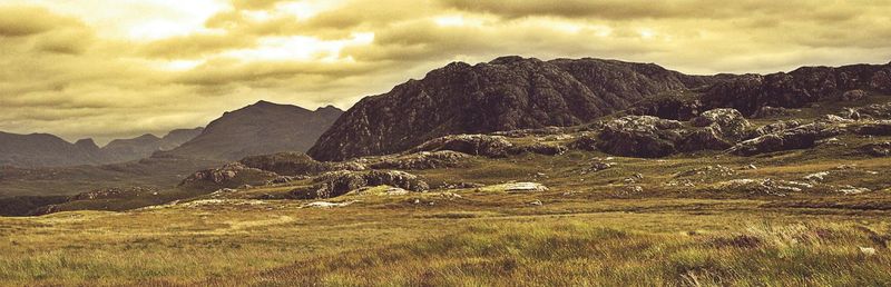 Scenic view of mountains against cloudy sky