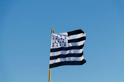 Low angle view of brittany flag waving against clear blue sky