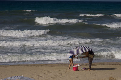 Boy on beach by sea