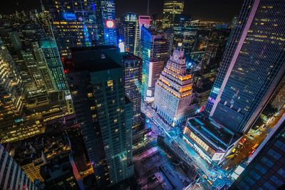 High angle view of city lit up at night