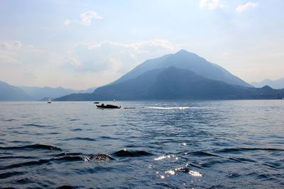 Scenic view of sea and mountains against sky