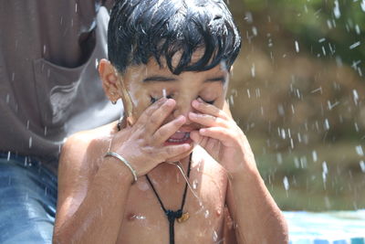 Close-up of shirtless boy in water