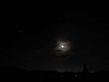 Low angle view of silhouette moon against sky at night