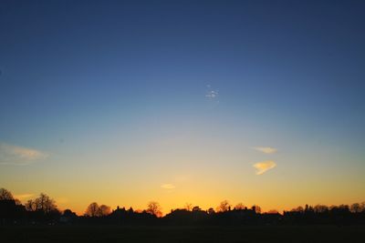 Silhouette trees against sky during sunset