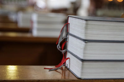 Close-up of bibles on bench in church