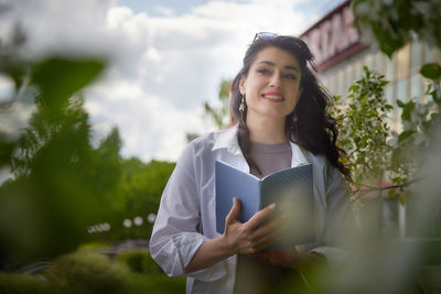 Portrait of young woman using mobile phone