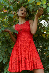 Low angle view of woman standing by plants