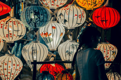 Rear view of people standing in market