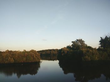 Scenic view of lake and trees against clear sky