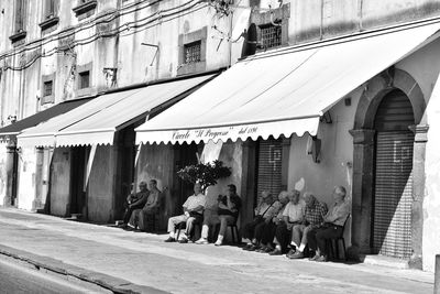 Statues on street amidst buildings in city