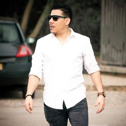 Young man wearing sunglasses standing outdoors
