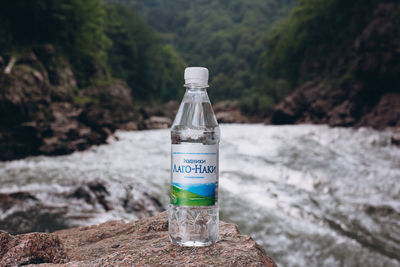 Close-up of water bottle on rock