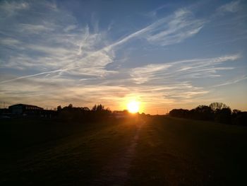 Scenic view of field against sky during sunset