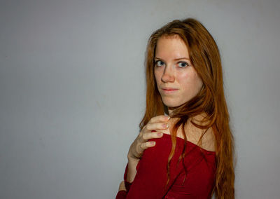 Portrait of a beautiful young woman against white background