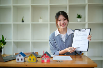 Portrait of young woman using digital tablet