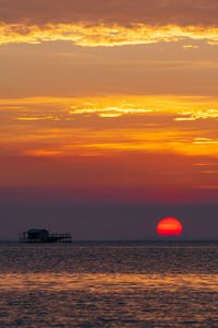 Scenic view of sea against romantic sky at sunset