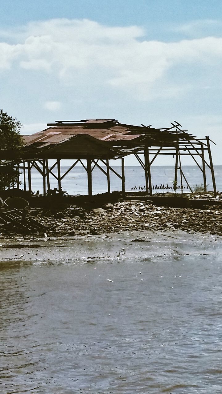 water, sky, built structure, architecture, waterfront, pier, cloud - sky, nature, sea, river, day, cloud, tranquility, wood - material, outdoors, tranquil scene, scenics, beauty in nature, beach, bridge - man made structure