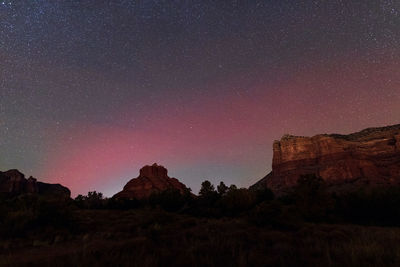 Red aurora in the night sky over bell rock and courthouse butte in sedona, arizona