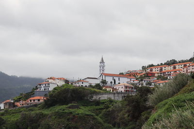 Buildings in city against sky