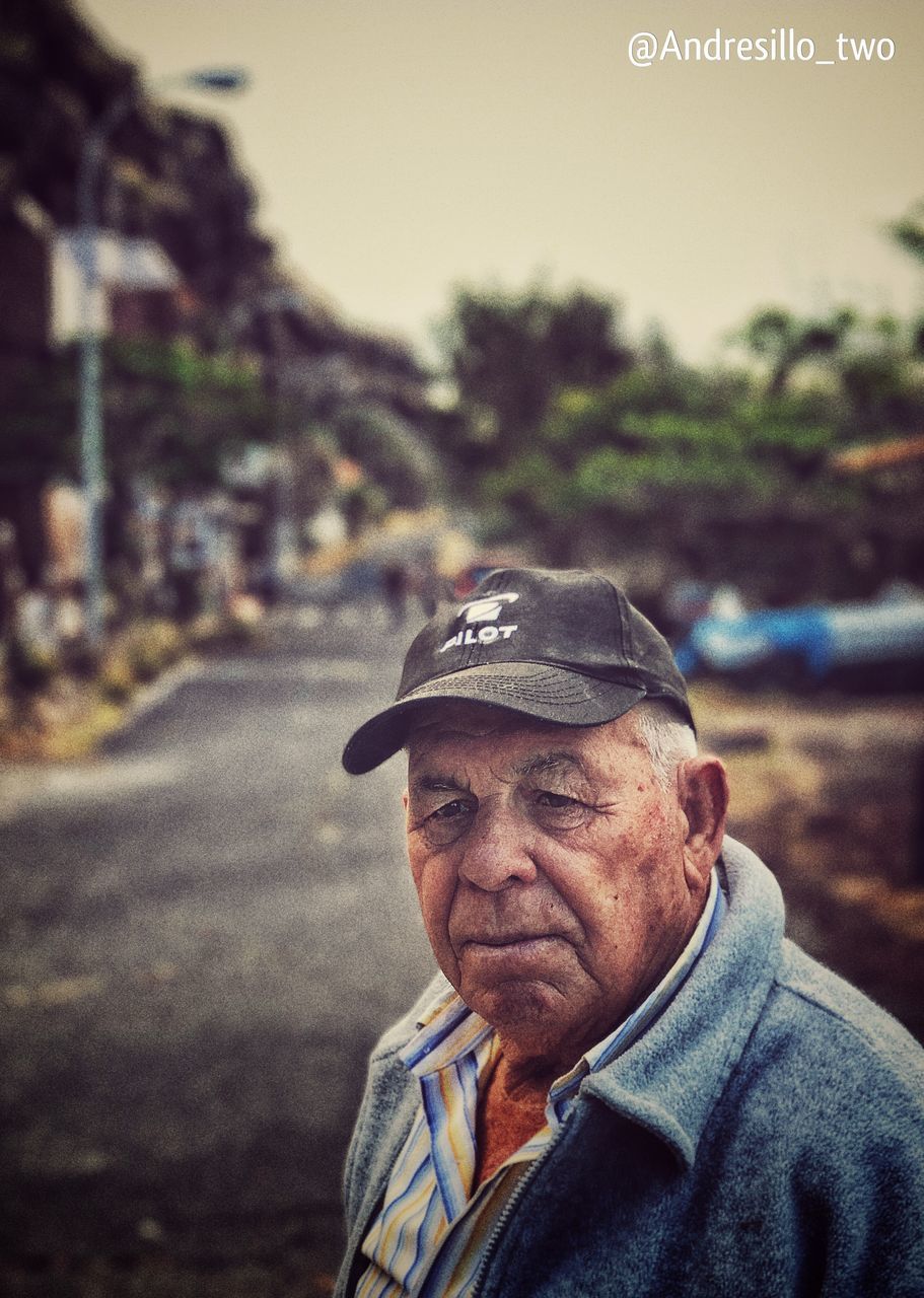 portrait, senior adult, one person, focus on foreground, headshot, senior men, men, real people, adult, males, day, looking at camera, cap, lifestyles, wrinkled, nature, clothing, city, outdoors