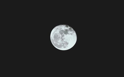 Low angle view of moon against sky at night