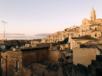 View of old buildings in city against clear sky