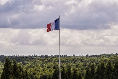 Scenic view of flag on landscape against sky