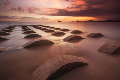 Scenic view of beach against sky during sunset