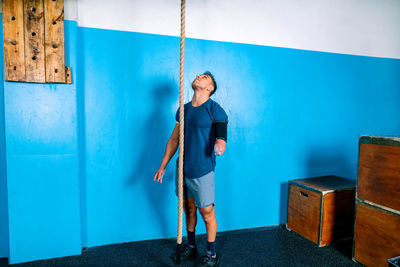 Man standing against wall