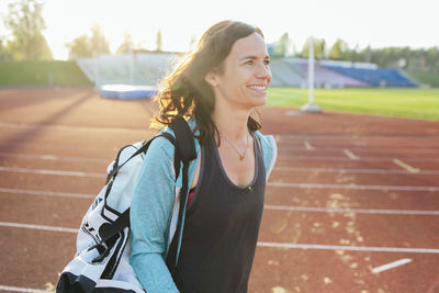 Smiling woman on running track