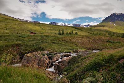 Scenic view of landscape against cloudy sky