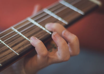 Little girl plays the guitar.