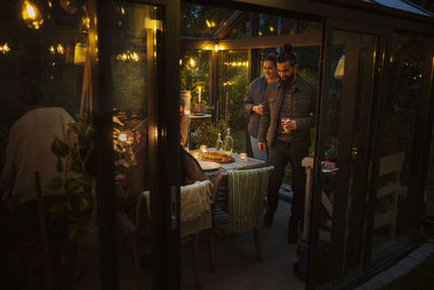 Friends having meal in greenhouse