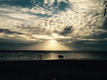 Scenic view of sea against cloudy sky