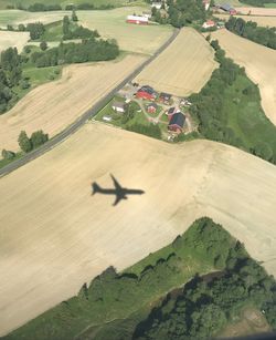 High angle view of airplane flying over land